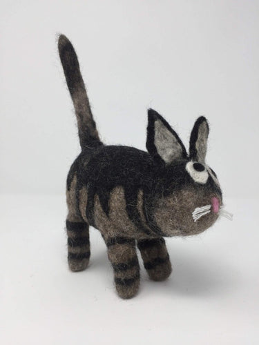 Picture of a black and brown striped felt cat toy standing on a white surface 