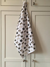 Load image into Gallery viewer, White cat-themed kitchen towel hanging from a kitchen cupboard handle

