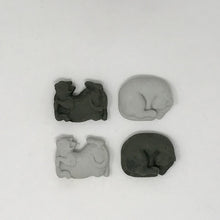 Load image into Gallery viewer, Two black and two grey cat shaped erasers laying flat on an all white surface
