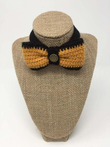 Picture of a ginger and black colored pet bow tie collar around a tan brown bust 