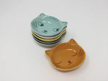 Load image into Gallery viewer, Picture of five mini cat face bowls stacked on top of each other with another orange mini bowl next to the stack
