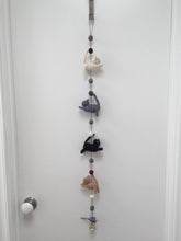 Load image into Gallery viewer, Picture of a felt cat door garland featuring four cats and a mouse hanging from a white door
