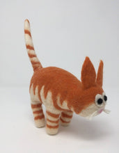 Load image into Gallery viewer, Picture of a striped orange felt cat standing on an all white surface 
