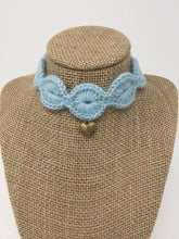 Load image into Gallery viewer, Picture of a light blue pet collar with a gold colored pendant around a tan brown bust 
