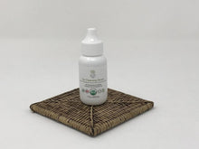 Load image into Gallery viewer, White bottle of a cat ear cleaning solution standing on a wicker surface with a white background
