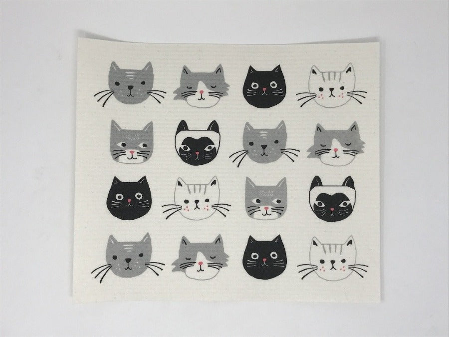 White dish rack mat featuring white, black, and grey cats, laying flat on a white surface