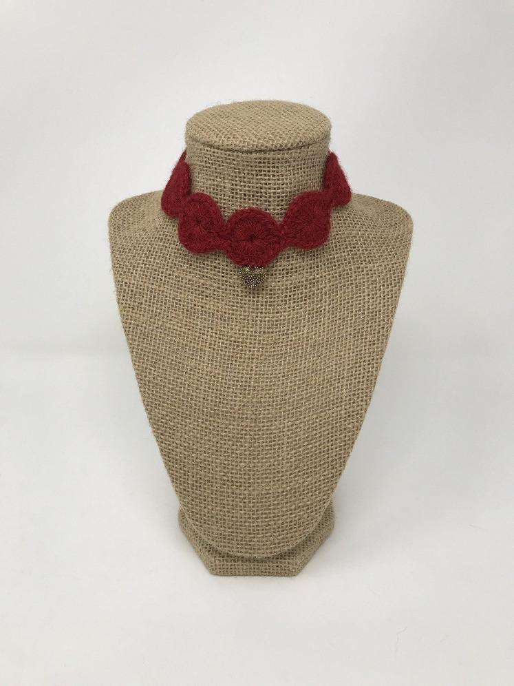 Picture of a red pet collar with a gold colored charm around a tan brown bust 
