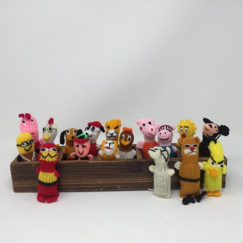 Picture of colorful collection of hand-knitted catnip toys inside of a wooden trough 