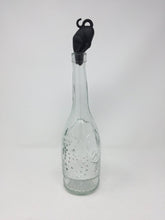 Load image into Gallery viewer, Picture of a black cat-themed bottle stopper with the cat&#39;s face inside the top of the bottle with a white background
