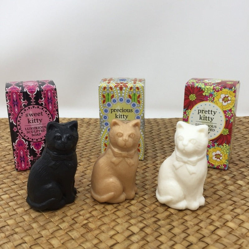 Three cat shaped soap bars, one black, one tan brown, and the third white