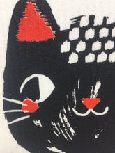 Load image into Gallery viewer, Close up picture of a black cat&#39;s face on a white sponge dish rack towel 
