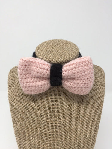 Pink and black Hand Crochet Alpaca Wool Pet Bow Tie around a tan brown bust 