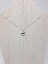 Load image into Gallery viewer, Picture of a sterling silver necklace with a circular pendant and a black paw inside of the pendant
