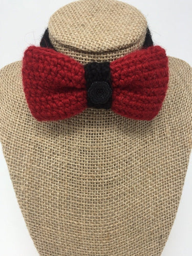 Red and black hand-knitted pet bow tie collar around a tan brown bust 