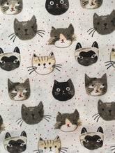 Load image into Gallery viewer, Close up picture of a white cat-themed kitchen towel featuring numerous cats on it
