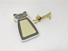 Load image into Gallery viewer, Siamese cat-themed notepad with gold colored pen on a white background
