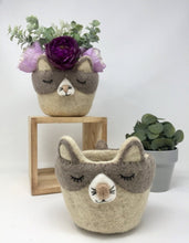 Load image into Gallery viewer, Two grey and off-white felt cat pot holders with flowers inside of one of them
