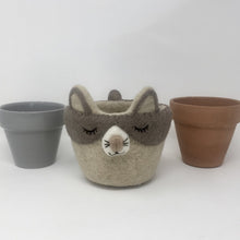Load image into Gallery viewer, Grey and off-white felt cat plant holder with two ceramic pots on either side standing on an all white surface

