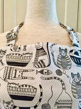Load image into Gallery viewer, Close up picture of a black and white kitchen apron featuring black and white cats
