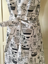 Load image into Gallery viewer, Close up picture of a black and white kitchen apron featuring black and white cats
